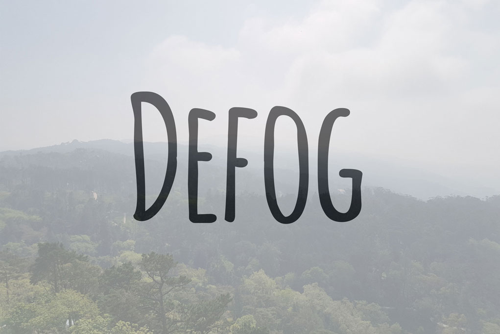 The Defog app logo is set in front of a fogged view of a lush green mountainside